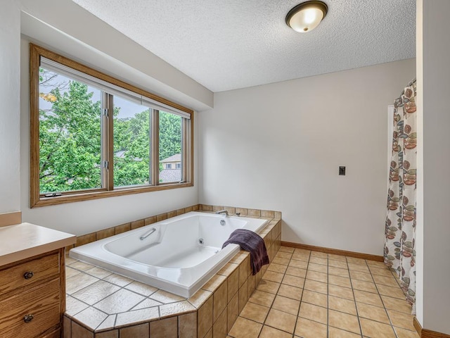 4125 Bridgewater Cir, Vadnais Heights, MN 55127 - bathroom with a textured ceiling, healthy amount of natural light, a tub with jets, vanity, and tile patterned floors