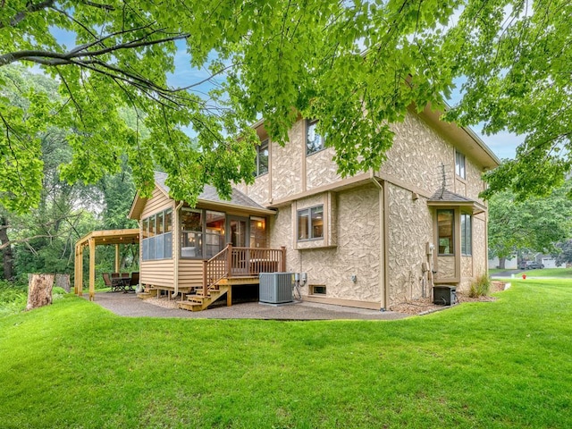 4125 Bridgewater Cir, Vadnais Heights, MN 55127 - back of property featuring a sunroom, a patio area, stucco siding, and a lawn