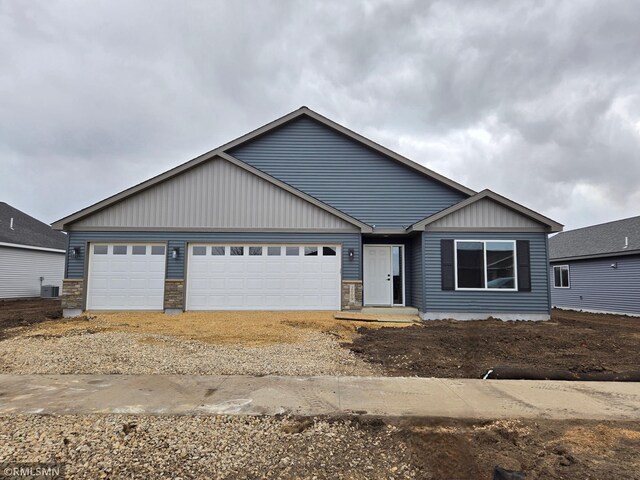 2001 Essler Dr, Saint Peter, MN 56082 - view of front of home featuring a garage, board and batten siding, and driveway