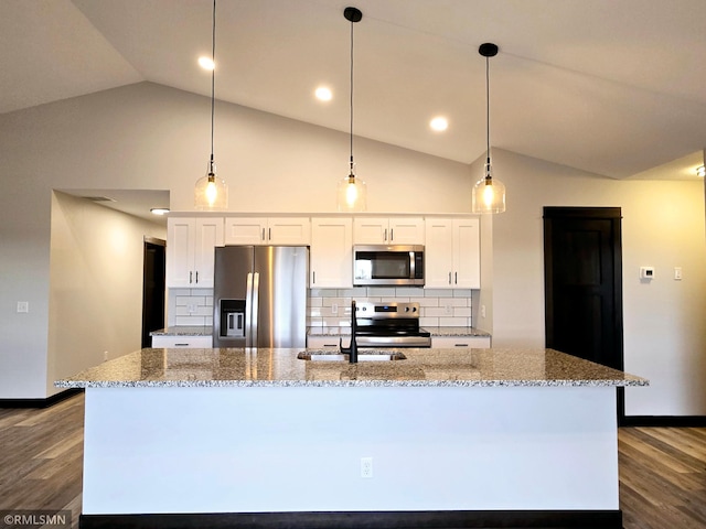 2001 Essler Dr, Saint Peter, MN 56082 - kitchen featuring appliances with stainless steel finishes, lofted ceiling, a center island with sink, tasteful backsplash, and white cabinets