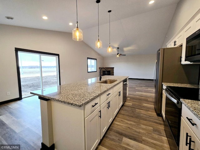 2001 Essler Dr, Saint Peter, MN 56082 - kitchen with black appliances, a ceiling fan, a fireplace, lofted ceiling, and white cabinetry