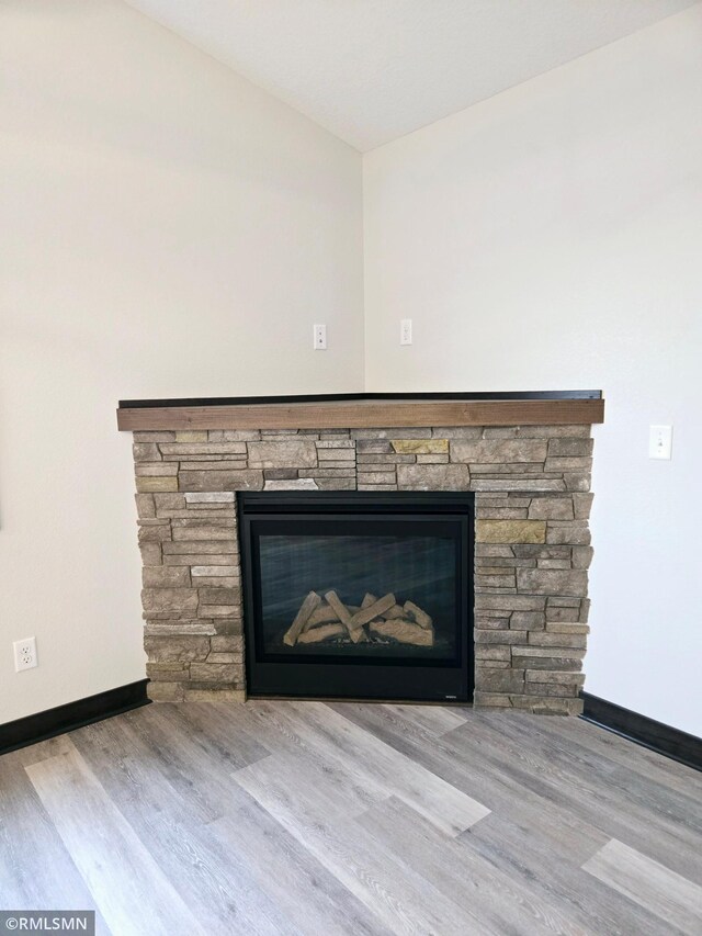 2001 Essler Dr, Saint Peter, MN 56082 - detailed view of a stone fireplace and wood finished floors