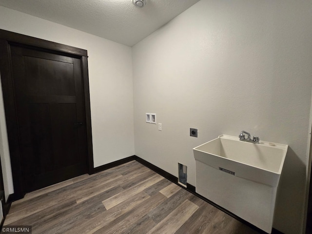2001 Essler Dr, Saint Peter, MN 56082 - washroom with hookup for an electric dryer, dark wood-style floors, washer hookup, and a textured ceiling