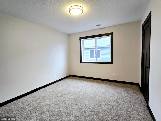 2001 Essler Dr, Saint Peter, MN 56082 - spare room featuring light colored carpet, a textured ceiling, and a smoke detector