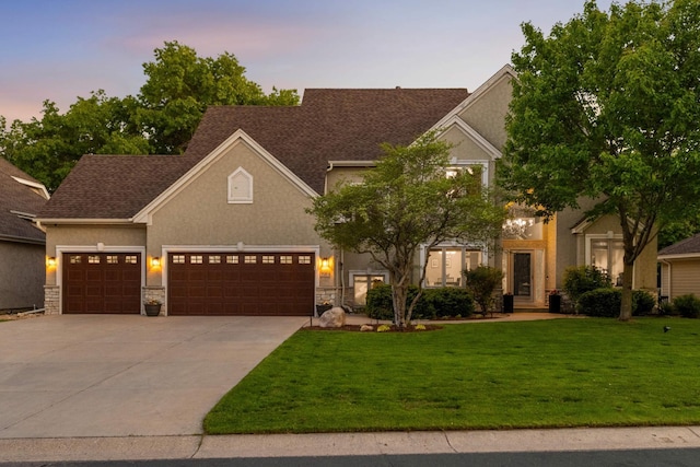 3583 Woodland Trl, Eagan, MN 55123 - view of front of property featuring a lawn, driveway, stucco siding, a garage, and stone siding