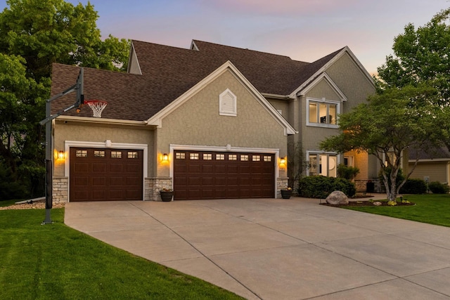 3583 Woodland Trl, Eagan, MN 55123 - view of front of property featuring concrete driveway, stone siding, an attached garage, and a front yard