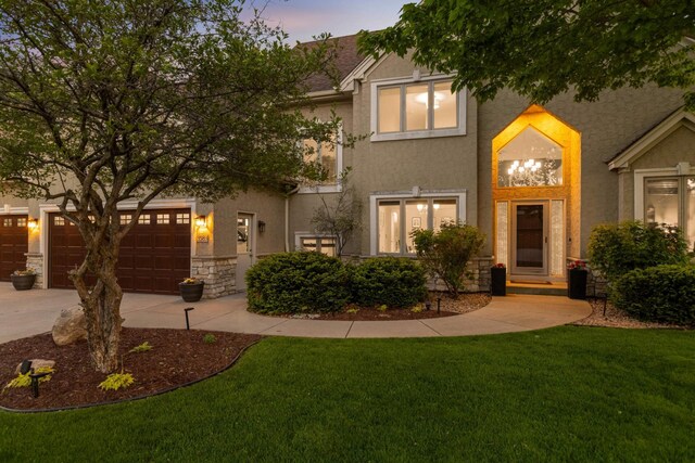 3583 Woodland Trl, Eagan, MN 55123 - view of front facade with stucco siding, driveway, a lawn, and a garage