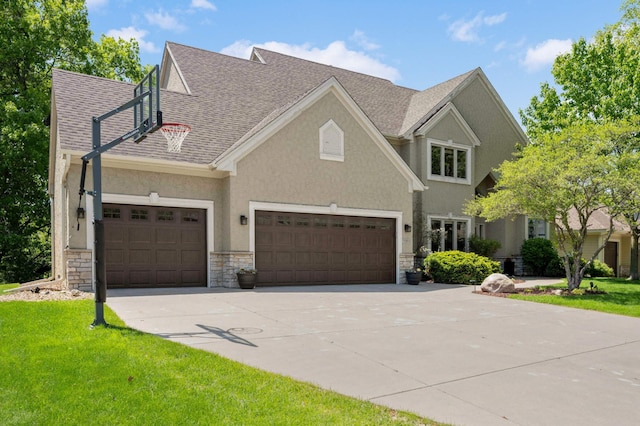 3583 Woodland Trl, Eagan, MN 55123 - view of front of home with concrete driveway, stone siding, a garage, stucco siding, and a shingled roof