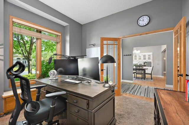 3583 Woodland Trl, Eagan, MN 55123 - home office featuring a chandelier, a textured ceiling, and wood finished floors