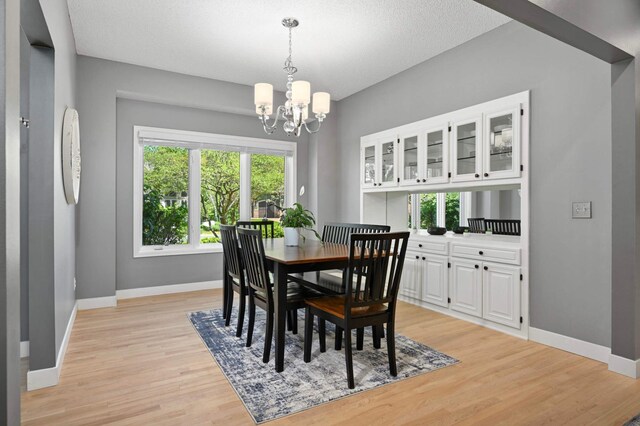 3583 Woodland Trl, Eagan, MN 55123 - dining space featuring light wood finished floors and a chandelier