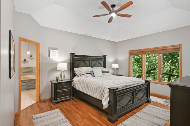 3583 Woodland Trl, Eagan, MN 55123 - bedroom featuring wood finished floors, ensuite bathroom, and ceiling fan