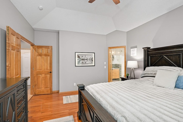 3583 Woodland Trl, Eagan, MN 55123 - bedroom with light wood-style flooring, vaulted ceiling, a ceiling fan, and ensuite bath