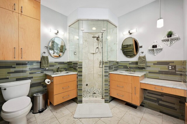 3583 Woodland Trl, Eagan, MN 55123 - full bathroom with tile patterned floors, a stall shower, two vanities, backsplash, and tile walls