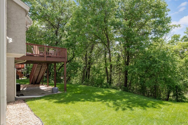 3583 Woodland Trl, Eagan, MN 55123 - view of green lawn with stairway, a patio area, and a wooden deck