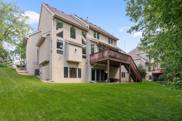 3583 Woodland Trl, Eagan, MN 55123 - rear view of property featuring stucco siding, stairs, a deck, and a lawn