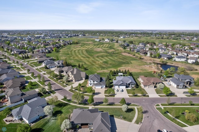 4169 58th St S, Fargo, ND 58104 - aerial view of property and surrounding area featuring nearby suburban area, a large body of water, and a golf course