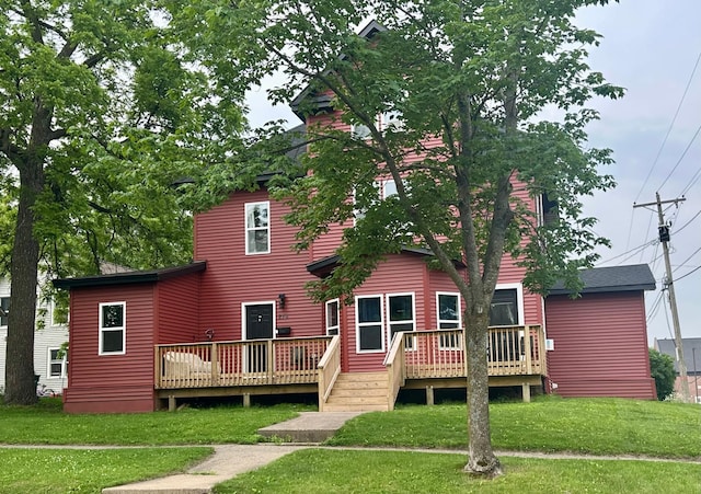 216 Elm St, River Falls, WI 54022 - back of property with a yard and a wooden deck