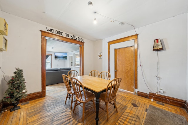 216 Elm St, River Falls, WI 54022 - dining area featuring baseboards and hardwood / wood-style flooring