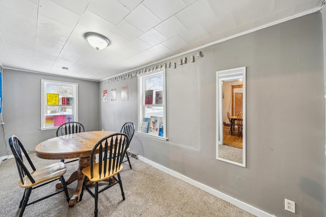 216 Elm St, River Falls, WI 54022 - dining room featuring carpet and baseboards