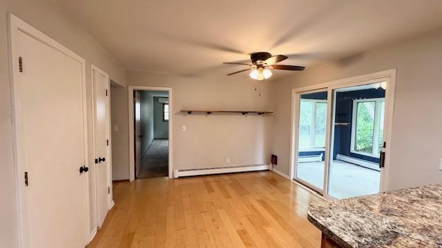 811 Myrtle St, Buffalo, MN 55313 - unfurnished dining area with baseboard heating, a baseboard radiator, light wood-style flooring, and ceiling fan