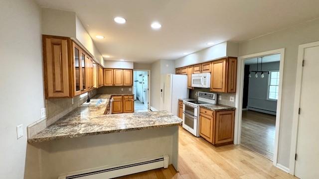 811 Myrtle St, Buffalo, MN 55313 - kitchen featuring white appliances, baseboard heating, a baseboard radiator, light wood finished floors, and a peninsula