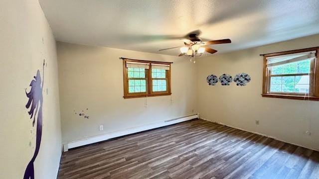 811 Myrtle St, Buffalo, MN 55313 - spare room featuring plenty of natural light, baseboard heating, a ceiling fan, and wood finished floors