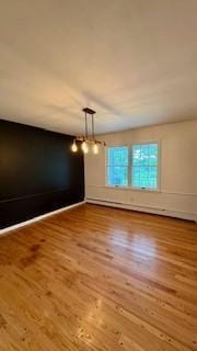 811 Myrtle St, Buffalo, MN 55313 - unfurnished room featuring wood finished floors and a chandelier