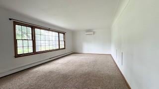 811 Myrtle St, Buffalo, MN 55313 - spare room featuring a baseboard radiator and carpet floors