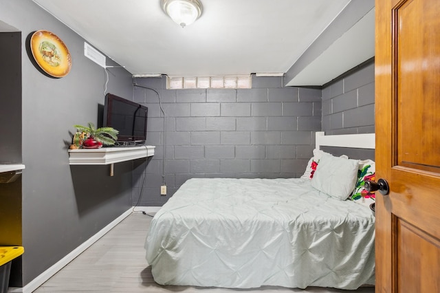 4638 Johnson St NE, Columbia Heights, MN 55421 - bedroom featuring light wood-style flooring and concrete block wall