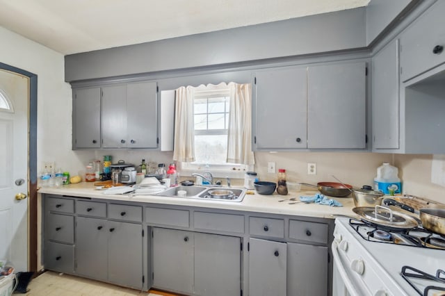 4638 Johnson St NE, Columbia Heights, MN 55421 - kitchen featuring gray cabinetry, gas range gas stove, and light countertops