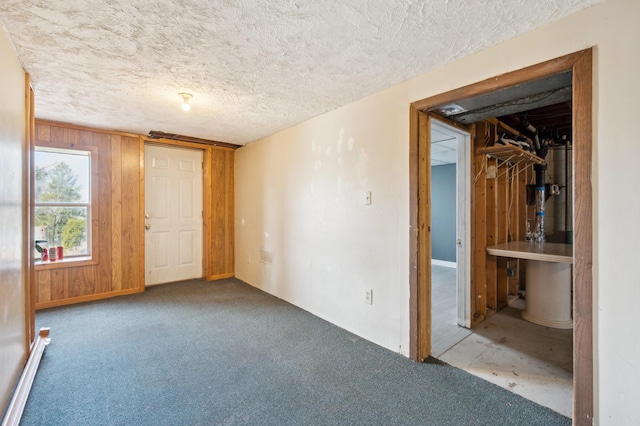 4638 Johnson St NE, Columbia Heights, MN 55421 - unfurnished bedroom with carpet flooring, a textured ceiling, water heater, wooden walls, and baseboard heating