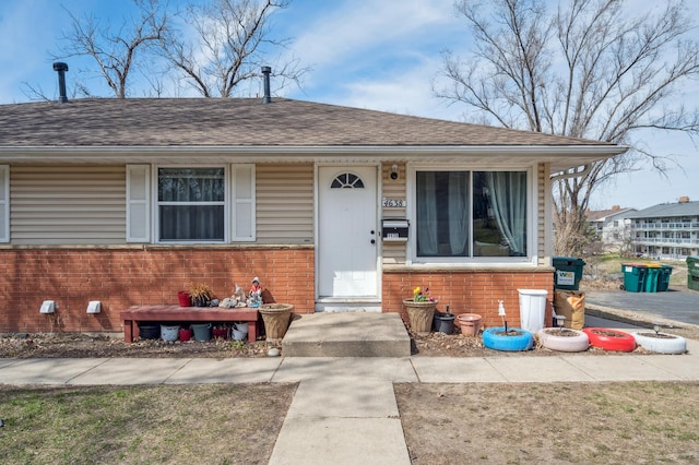 4638 Johnson St NE, Columbia Heights, MN 55421 - bungalow featuring brick siding and a shingled roof