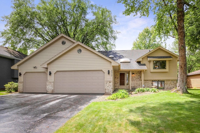 2017 87th Trl N, Brooklyn Park, MN 55443 - tri-level home with brick siding, a garage, asphalt driveway, and a front lawn