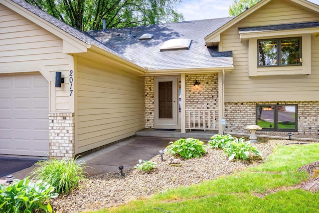 2017 87th Trl N, Brooklyn Park, MN 55443 - doorway to property with an attached garage, brick siding, and a shingled roof