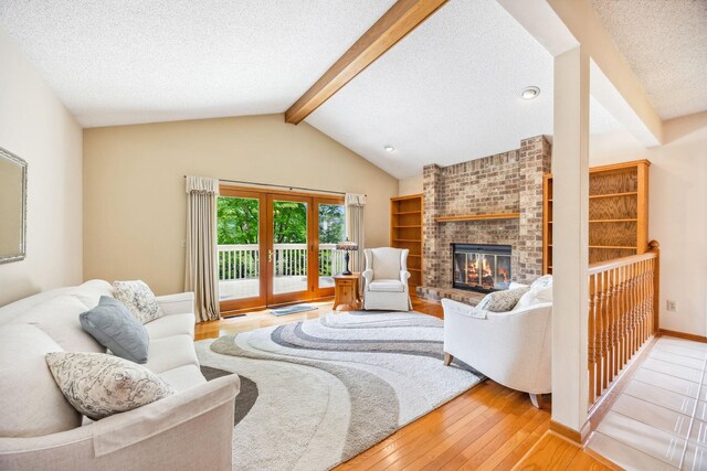 2017 87th Trl N, Brooklyn Park, MN 55443 - living area with a textured ceiling, light wood finished floors, and a brick fireplace
