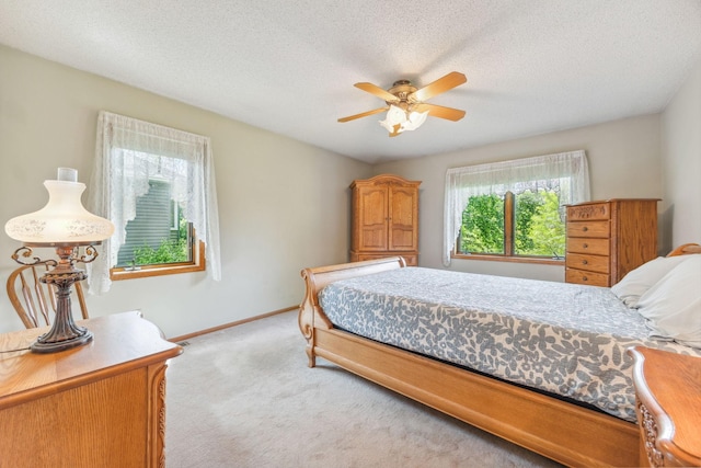 2017 87th Trl N, Brooklyn Park, MN 55443 - bedroom with light carpet, a ceiling fan, and a textured ceiling