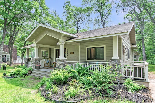 8619 Dove St, Breezy Point, MN 56472 - craftsman house featuring a porch, roof with shingles, and a front yard