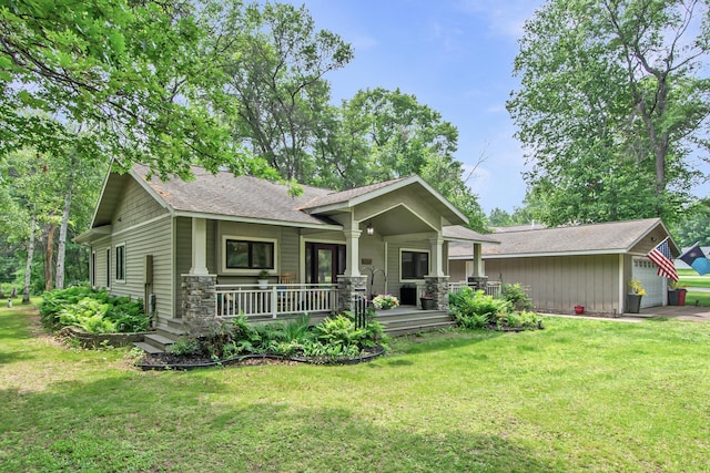 8619 Dove St, Breezy Point, MN 56472 - craftsman-style house with covered porch, stone siding, a front yard, and an outbuilding