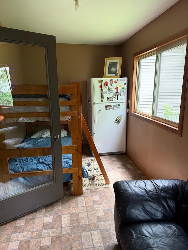 8619 Dove St, Breezy Point, MN 56472 - bedroom with freestanding refrigerator and brick patterned floors