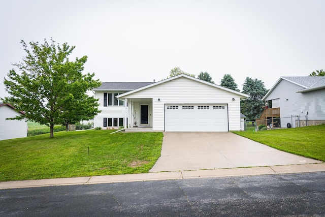 415 3rd St NW, Elgin, MN 55932 - tri-level home with concrete driveway and an attached garage