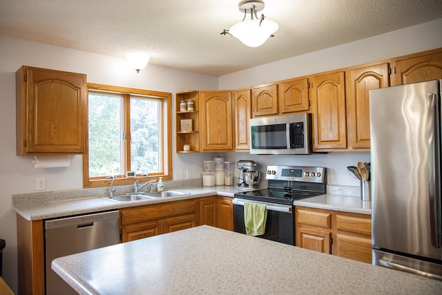 415 3rd St NW, Elgin, MN 55932 - kitchen featuring appliances with stainless steel finishes, light countertops, open shelves, brown cabinetry, and a textured ceiling