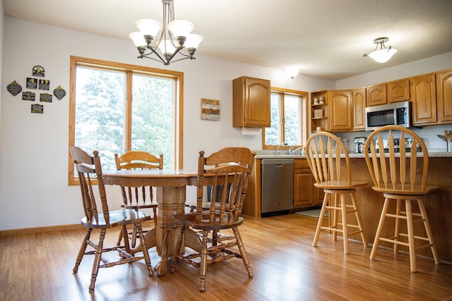 415 3rd St NW, Elgin, MN 55932 - dining room featuring a chandelier and light wood-type flooring