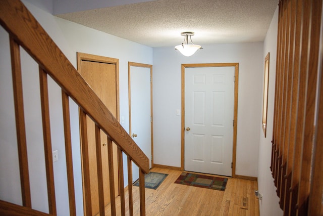 415 3rd St NW, Elgin, MN 55932 - entryway featuring light wood finished floors and a textured ceiling