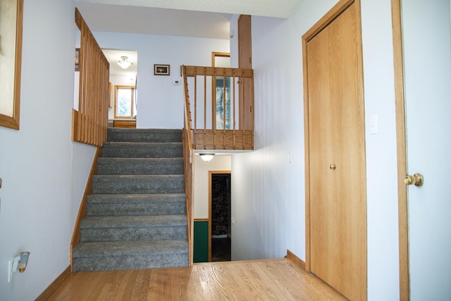 415 3rd St NW, Elgin, MN 55932 - stairway featuring wood finished floors and baseboards