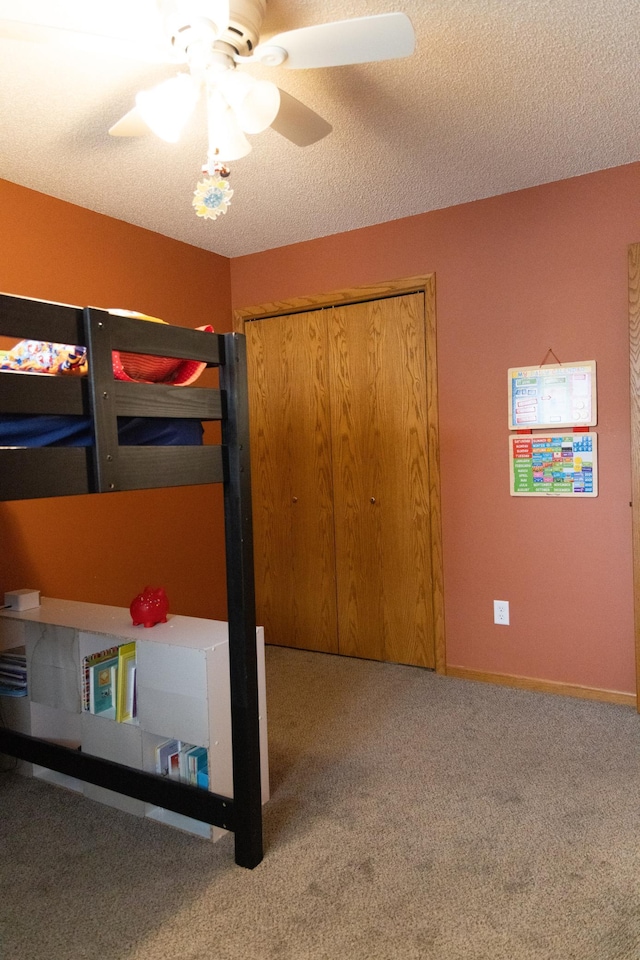 415 3rd St NW, Elgin, MN 55932 - unfurnished bedroom featuring carpet, a ceiling fan, a closet, and a textured ceiling