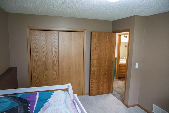 415 3rd St NW, Elgin, MN 55932 - carpeted bedroom with a closet and a textured ceiling