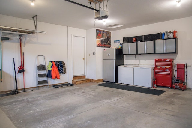 415 3rd St NW, Elgin, MN 55932 - garage featuring freestanding refrigerator, a garage door opener, and refrigerator