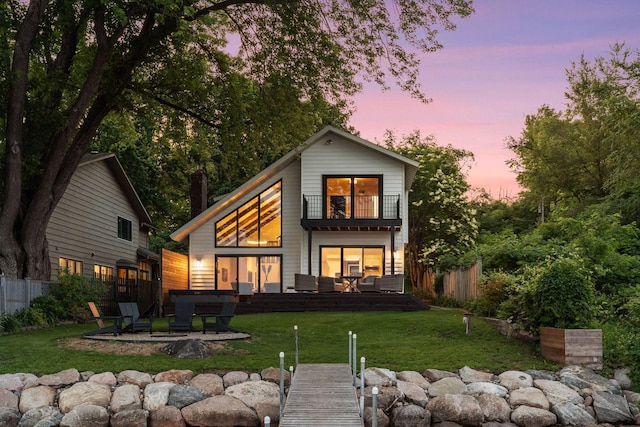 6641 Halstead Ave, Mound, MN 55364 - back of house at dusk with a balcony and a patio area