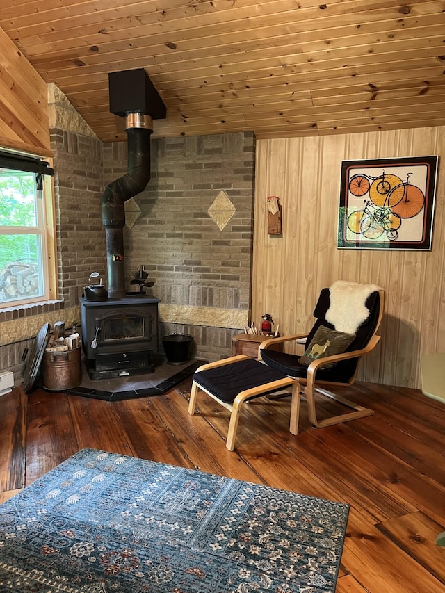 38010 Clover Cir, Hinckley, MN 55037 - sitting room with a wood stove, hardwood / wood-style flooring, wood walls, and wood ceiling