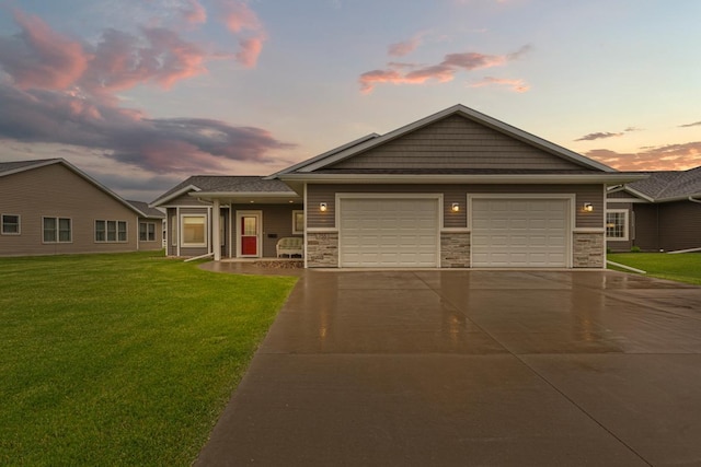755 Escalade Ln SE, Owatonna, MN 55060 - view of front of property with concrete driveway, an attached garage, a lawn, and stone siding
